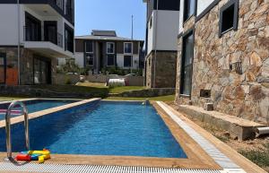 a swimming pool with a toy in front of a building at Villa Ögreten in Aydın