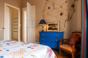 a bedroom with a bed and a blue dresser at Chambres d'hotes Lunidor in Lusigny-sur-Barse