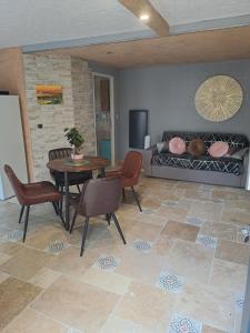 a living room with a table and chairs and a couch at Drissia&Othman in Carcassonne