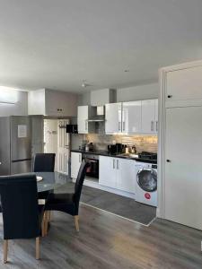 a kitchen with a table and chairs in a room at Lovely Studio in Dublin City Centre in Dublin