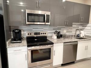 a kitchen with stainless steel appliances and a microwave at 505 Relaxing 1BR apartment in center city of Philly in Philadelphia