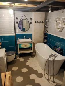 a bathroom with a tub and a sink and a toilet at RedCity LOFT 129 in Żyrardów +12 photos