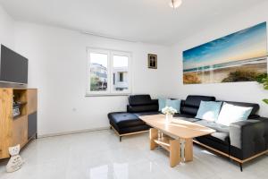 a living room with a couch and a table at Apartment Kamila in Krk