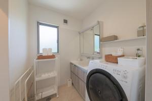 a laundry room with a washing machine and a sink at Through Time Amami - Vacation STAY 58444v in Amami