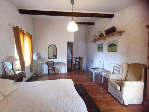 a bedroom with a bed and a table and chairs at Chambre de charme in Cavanac