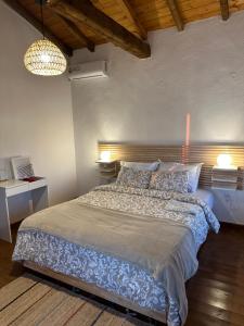 a bedroom with a large bed in a room at Petrospito by the sea! in Neos Marmaras