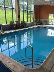 a large swimming pool with chairs in a building at Best Western Plus Hotel & Conference Center in Baltimore