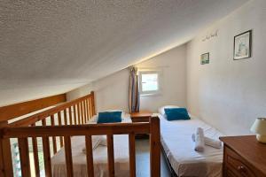 En eller flere senge i et værelse på Maison 5 personnes côté plage