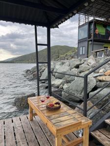 a picnic table with a bowl of fruit on a dock at Altitude 1900 Dive Resort, Lake Sevan in Chambarak +53 photos