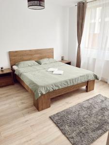 a bedroom with a bed and a rug at NS apartment 2 in Cluj-Napoca