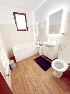 La salle de bains blanche est pourvue de toilettes et d'un lavabo. dans l'établissement NS apartment 2, à Cluj-Napoca