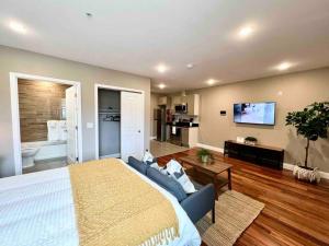 a bedroom with a large bed and a living room at 402 Stylish luxe Apt at center city self check-in in Philadelphia