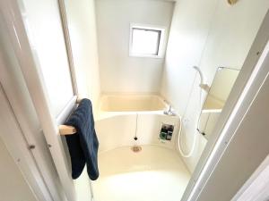 baño pequeño con ducha y lavamanos en Sapan Hasegawa - Vacation STAY 14781 en Kitakyushu
