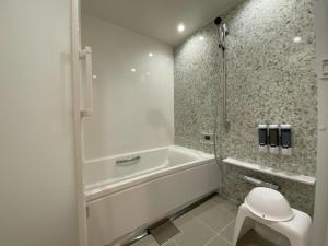 baño blanco con bañera y aseo en THE LAND HOTEL - Vacation STAY 89418v, en Arao