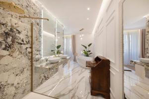 a bathroom with two sinks and two mirrors at Île Déluxe Apartment in Sorrento +21 photos