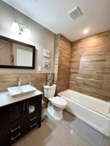 a bathroom with a toilet and a tub and a sink at 407 Sweetest cottage 1bed room Apt in center city in Philadelphia
