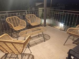 un grupo de sillas y una mesa en el balcón en Villa ALONIA, en Kalamata