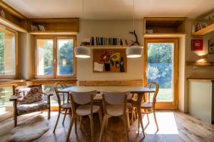 a dining room with a table and chairs at LA CASA NEL BOSCO 