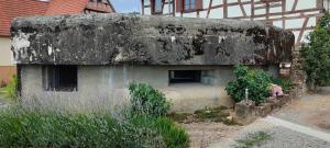 an old building that is sitting in front of a building at Au Bunker 67 in Rott