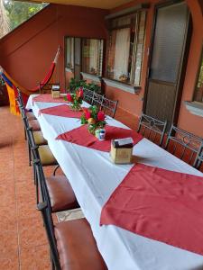 a row of long tables with red napkins on them at Hotel Torre Fuerte in Venecia