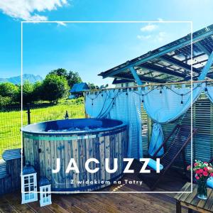 a hot tub on a deck with a sign on it at Villa 84 & Apartments Jacuzzi & Sauna in Zakopane