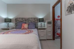 a bedroom with a bed and two lamps and a dresser at CASA ANA in Alcalá