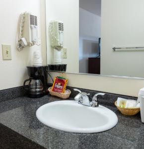 a bathroom counter with a sink and a mirror at AbbyCreek Inn in Winthrop