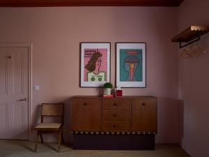 a room with a dresser and two pictures on the wall at Margate House in Kent