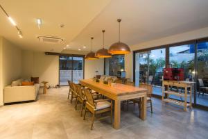 a dining room with a large wooden table and chairs at Hotel Pastel Kaş in Kas