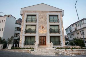 a building with a sign on the front of it at Hotel Pastel Kaş in Kaş