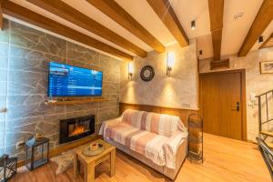 a living room with a couch and a fireplace at Pirin Golf&Spa Apartment 17 in Razlog