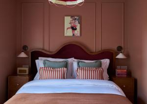 a bedroom with a large bed with two pillows at Margate House in Kent