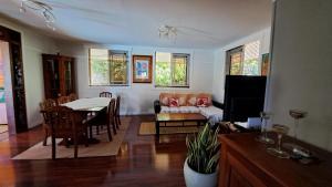 a living room with a table and a couch at TAHITI - Villa Fara in Papara