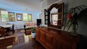 a living room with a large wooden dresser with a mirror at TAHITI - Villa Fara in Papara
