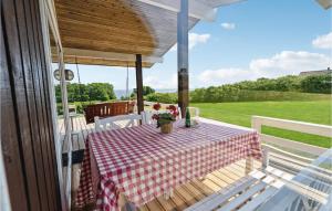 a table with a checkered table cloth on a porch at Holiday Home Harresbæk Iii in Skovby