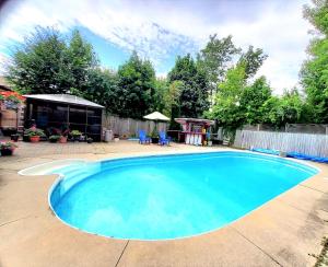 a large blue swimming pool in a yard at Cozy and quiet house with private swimming pool in Toronto
