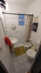 a small bathroom with a toilet and a sink at CASA DE LA LAGUNA in Ushuaia