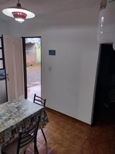 a dining room with a table and chairs and a light at Departamento Céntrico in Oberá