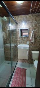 a bathroom with a sink and a toilet and a mirror at Angel Ilha Flats e Varanda da Praia in Abraão