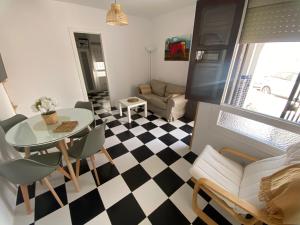 a living room with a black and white checkered floor at CASA RETINTO in Vejer de la Frontera