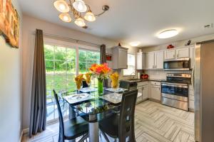 a kitchen with a glass table with flowers on it at Charlotte Home about 9 Mi to Bank of America Stadium! in Charlotte