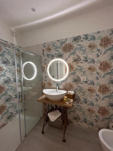 a bathroom with a sink and a shower and a mirror at L'Étoile luxury b&b in Tropea +65 photos
