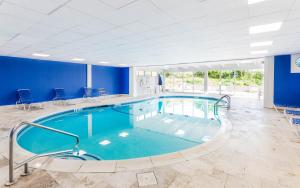 a pool in a large room with blue walls at Wavecrest Resort in Montauk