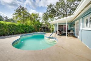 a swimming pool in the backyard of a house at Near Busch Gardens Sunny Florida Retreat with Pool! in Palm Harbor