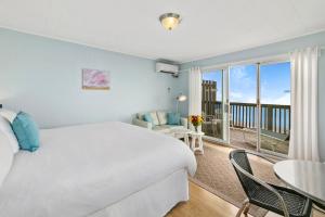 a hotel room with a bed and a balcony at Wavecrest Resort in Montauk