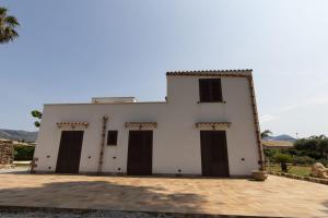 a large white building with four doors on it at Villa Albamonte in Carini +87 photos