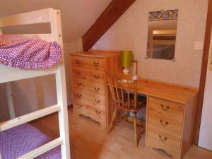 a bedroom with a desk and a bunk bed at CHALET du LAC in Saint-Rémy-sur-Durolle