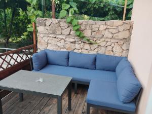 a blue couch and a table on a deck at Apartments Blanca in Vodice