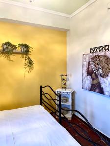a bedroom with a bed and a painting on the wall at Sea and Stone Villa in Afitos