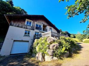 una casa blanca con garaje en una colina en Domaine des oiseaux, en Sapois